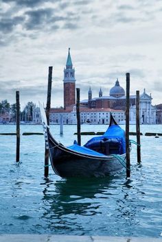 a gondola is tied to poles in the water