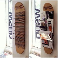 two skateboards mounted to the side of a wall next to a window with advertisements on it