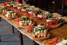 several wooden trays filled with different types of food on top of each other,