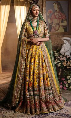 Pakistani Bridal Dress in Yellow Lehenga Choli Style is a classic masterpiece that will give the gorgeous bride a head-turning glamorous look on the most important day of your life. Lavish designs and embellishments give a perfect finishing to this stunning Bridal Lehenga Choli. Lehenga Choli: The choli is in an alluring yellow color is gracefully embellished with intricate designs, zardosi, sequins, tilla, and Resham. Shimmering ornaments, hanging motifs, and lavish contrast of colors make this choli a perfect choice to pair with the Bridal Lehenga. Bridal Lehenga: This Bridal Lehenga is emblazoned with the intricate designs, dabka, tilla, kora, Resham work, sequins, and crystals. The Yellow Lehenga has a huge flare and is adorned with Shimmering details and floral designs, making this Pa Choli Style, Yellow Lehenga Choli, Bridal Lehenga Pakistani, Pakistani Bridal Lehenga, Pakistani Bridal Dress, Yellow Lehenga, Pakistani Wedding Dress, Pakistani Bridal Dresses, Bridal Lehenga Choli