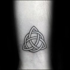 a black and white photo of a tattoo design on the ankle with an intertwined knot