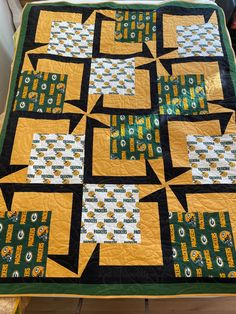 a green and yellow quilt on a table