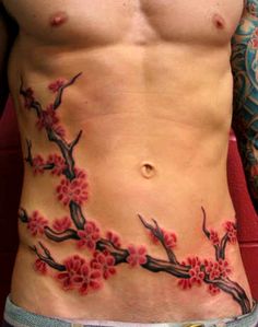 a man with tattoos on his stomach and chest