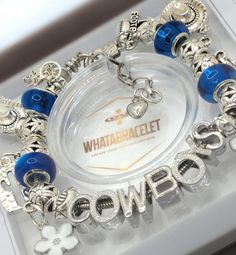 a bracelet with blue beads and charms on it that says, whataballet