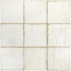 a white tiled wall with square tiles on it