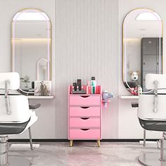 a pink dresser sitting in front of a mirror next to two white chairs with hair dryers on them