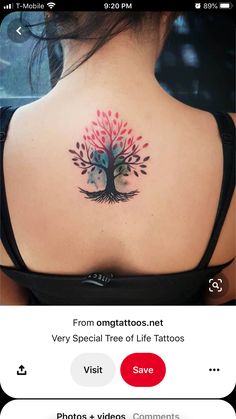 the back of a woman's shoulder with a tree tattoo on it