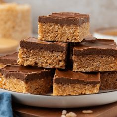 several pieces of chocolate peanut butter bars stacked on top of each other