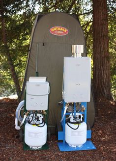 two water heaters sitting next to each other in the woods