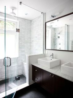 a bathroom with two sinks and a shower