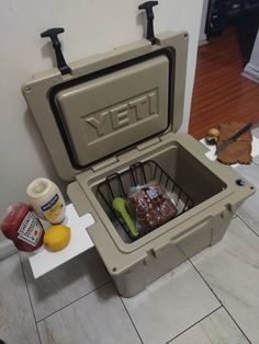 a cooler sitting on the floor with food in it