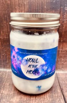 a jar filled with white liquid sitting on top of a wooden table next to a wall