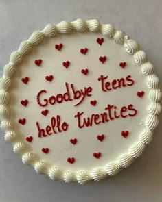 a white cake with red hearts on it that says goodbye teens, hello twenties