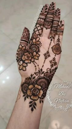 the hand is decorated with henna and flowers