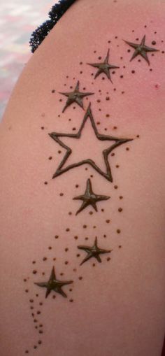 the back of a woman's shoulder with stars on it