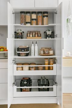 an organized pantry with lots of food in the shelves and containers on the bottom shelf