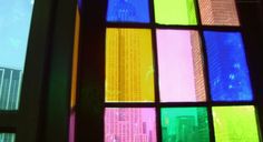 multicolored glass window with skyscrapers in the background