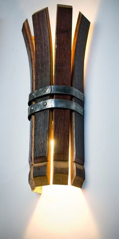 a wall light made out of wood and metal