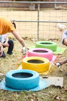 two children and an adult are playing with toys in the yard