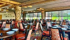 the inside of a restaurant with many tables and chairs set up for dinner or lunch