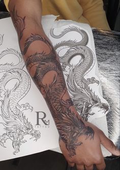 a man with a dragon tattoo on his arm