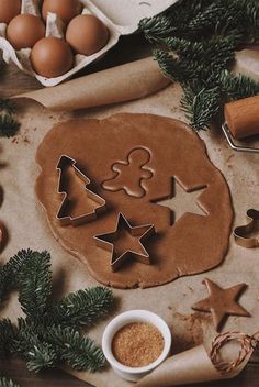 some cookies and other items on a table with christmas decorations, eggs and doughnuts