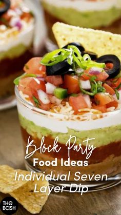 black party food ideas individual seven layer dip with tortilla chips on the side