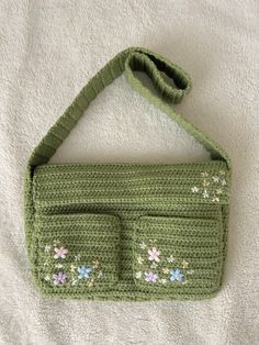 a green crocheted purse with two compartments