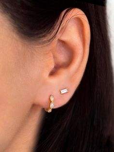 "These minimalist tiny baguette studs look beautiful with everything. An everyday staple piece, perfect for wearing in a second or third earhole or all by themselves for a dainty addition to your look. ∙ Sold individually (1 stud) or as a pair (2 studs). Both options are available on the dropdown menu. * D E T A I L S * ∙ Material: .925 Sterling Silver or 18K Gold Plated over .925 Sterling Silver ∙ Stone: Cubic zirconia ∙ Dimensions: 5mm x 2mm ∙ Hypoallergenic & nickel-free * P A C K A G I N Second Stud Earrings Indian, Minimalist Earrings With Baguette Diamonds, Minimalist Baguette Cubic Zirconia Jewelry, Second Ear Piercing, Baguette Diamond Earrings, Baguette Earrings, Second Hole Earrings, Baguette Studs, Tiny Gold Studs