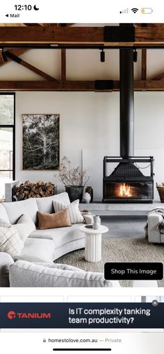 a living room filled with furniture and a fire place in the middle of the room