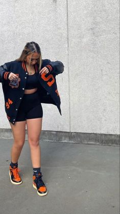 Letterman Jacket Outfit Shorts, Drake Concert Outfit Sneakers, Varsity Jacket Outfit With Shorts, Steer Wear Outfits, Baddie Baseball Outfits, Baddie Game Day Outfit, Red Street Wear Outfit, Sf Giants Outfit Women, Arcade Outfit Ideas Date