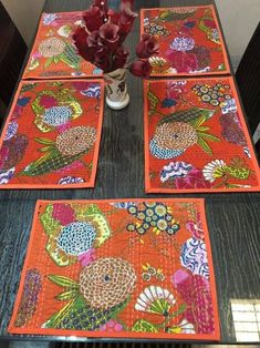 the table is set with place mats and flowers