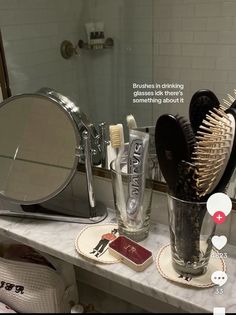 a bathroom counter topped with lots of hair brushes and personal care items next to a mirror