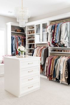 a walk in closet filled with lots of clothes