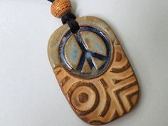 Peace Sign Ceramic Bead Necklace, Hippie Necklace * Light weight and with adjustable cording * 1 7/8" x 1 1/4"  * 10 grams  *3mm hole * Fired to cone 6 or 2,232 degrees for glaze richness and durability. Hippie Jewelry With Adjustable Cord For Gift, Hippie Jewelry With Adjustable Cord As Gift, Hippie Style Jewelry With Adjustable Cord For Gifts, Hippie Style Jewelry With Adjustable Cord As Gift, Adjustable Length Hippie Necklace For Gift, Adjustable Peace Sign Necklace, Adjustable Peace Sign Necklace As Gift, Adjustable Spiritual Jewelry With Peace Sign, Ceramic Bead Jewelry