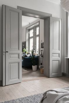 an open door leading into a bedroom with white walls