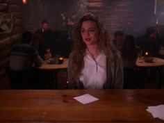 a woman sitting at a table in a restaurant