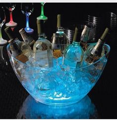 a glass bowl filled with lots of bottles