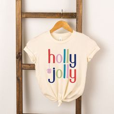 Looking for a cute tee for your kids? We have the perfect Holly Jolly graphic tee addition to their closet! White Holiday Graphic Tee, Jolly Christmas Shirts, Christmas Graphic Tees Target, White Christmas Graphic Tee Tops, Girls Graphic Tee, Holly Jolly, Girls Clothing, Comfortable Outfits, Sustainable Fashion