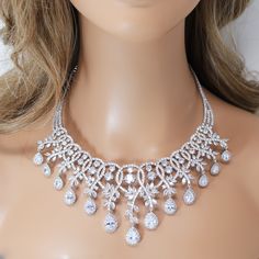 New to our Millennium collection, These beautiful romantic Crystal Luxury Flower Drops bridal earrings and necklace set are made of very fine quality of Swarovski crystals/ Cz diamonds and plated with platinum for your special day! Even we have hard time taking pictures because of their shine 😄 so we want to shine our brides on their special days. Simulated diamonds are also known as diamond simulants and include things like cubic zirconia (CZ), moissanite, and YAG. They can also include some n Clear Gemstones, Earrings And Necklace Set, Bridal Earrings Drop, Bridal Necklace Set, Necklace Bridal, Physical Properties, Glamour Makeup, Earrings And Necklace, Diamond Simulant