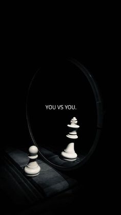 a mirror with chess pieces in it and the words you vs you written on it