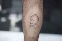 a man's leg with a face drawn on it