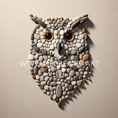 an owl made out of pebbles on a white surface with the eyes open