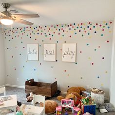 a child's playroom with toys and paintings on the wall