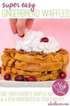 a stack of waffles topped with whipped cream and cranberries on a white plate