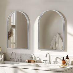 two bathroom sinks with mirrors above them