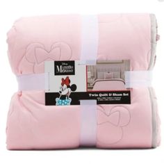 the pink mickey mouse bedding set is folded up and ready to be put in