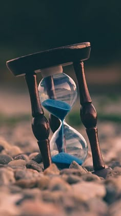 an hourglass sitting on top of some rocks