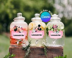 three glass jars filled with lemonade and lavenders on top of a wooden box