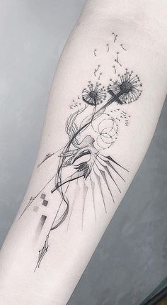 a dandelion tattoo on the left arm with black lines and dots in it